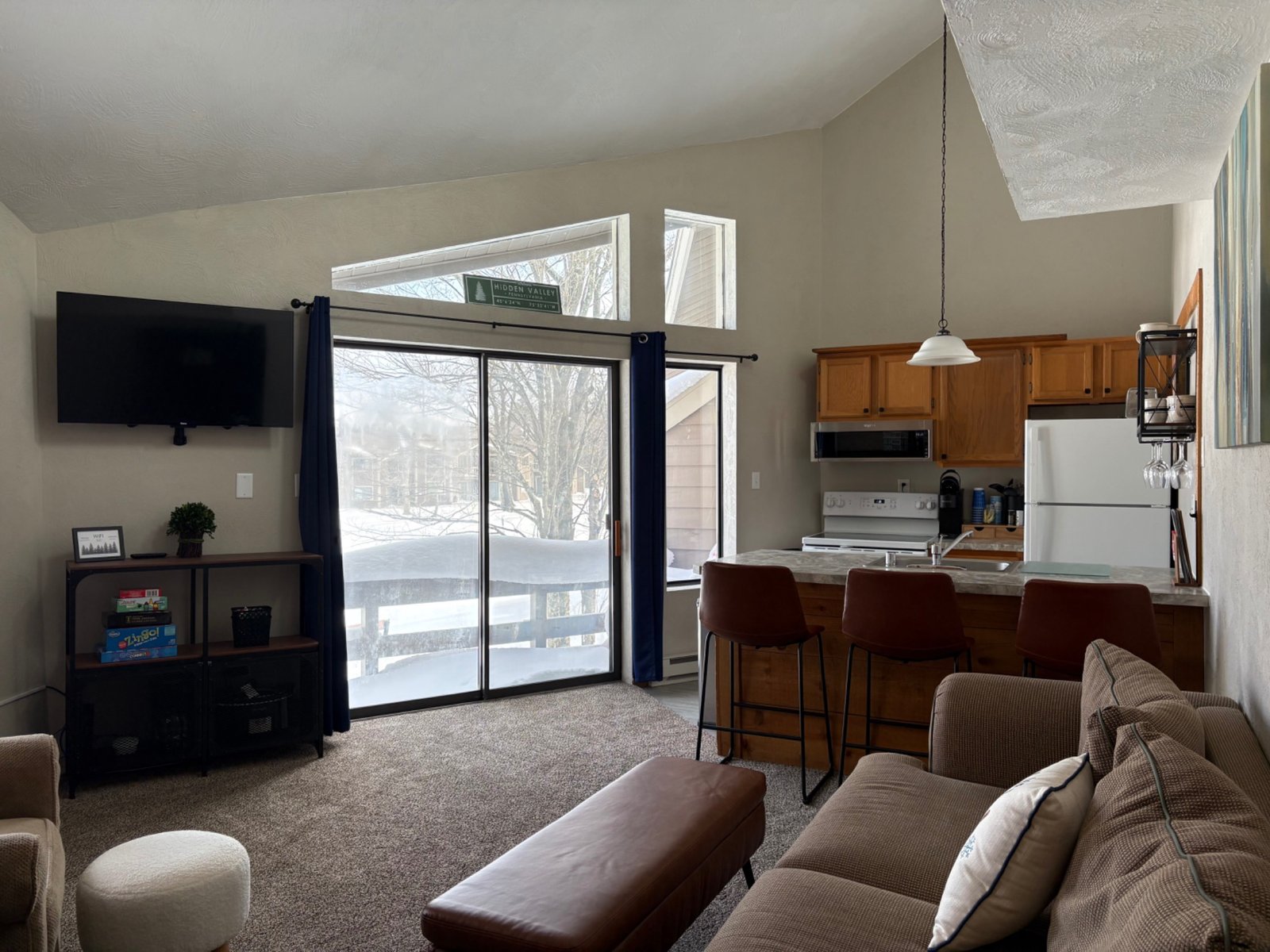Cozy living room with wood burning fireplace joined to the kitchen at Arcadia Mountainside