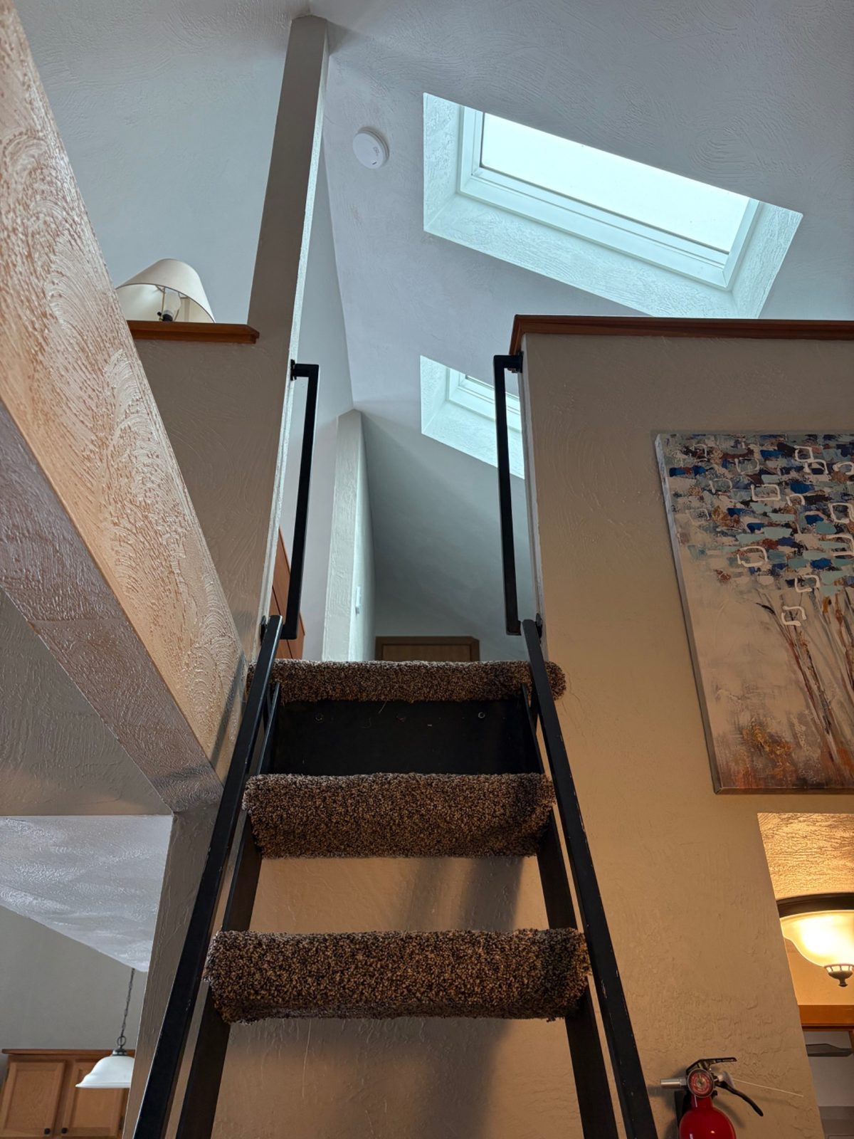The carpeted ladder leads up to the cozy loft at Arcadia Mountainside